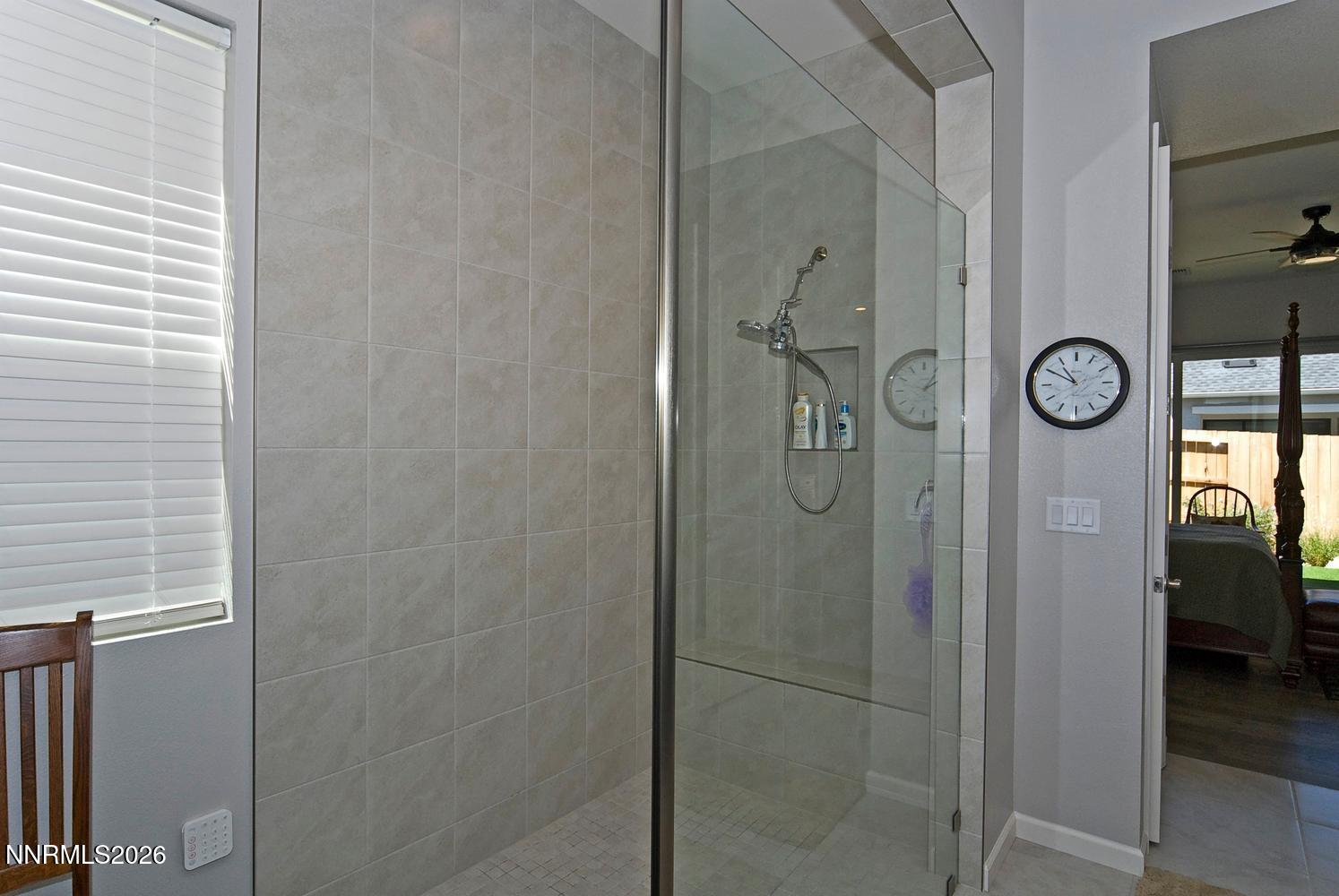 2332 Hammer Falls Drive Reno, NV 89521 - Photo 27 of 57 a bathroom with a shower and a mirror