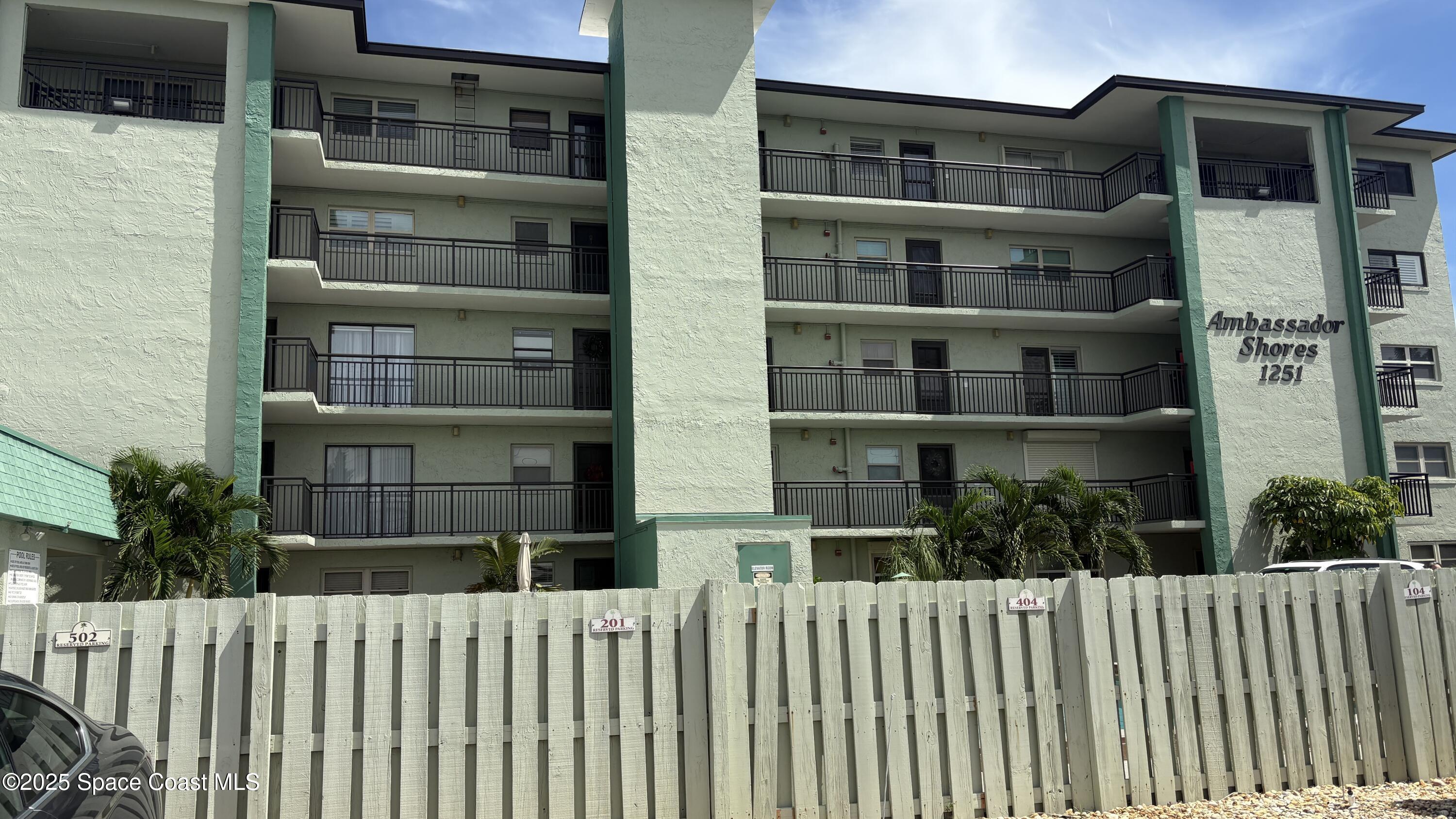 Undisclosed Address Cocoa Beach, FL 32931 - Photo 15 of 17 a front view of a building with a garden