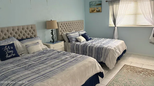 a bedroom with two beds and a couch