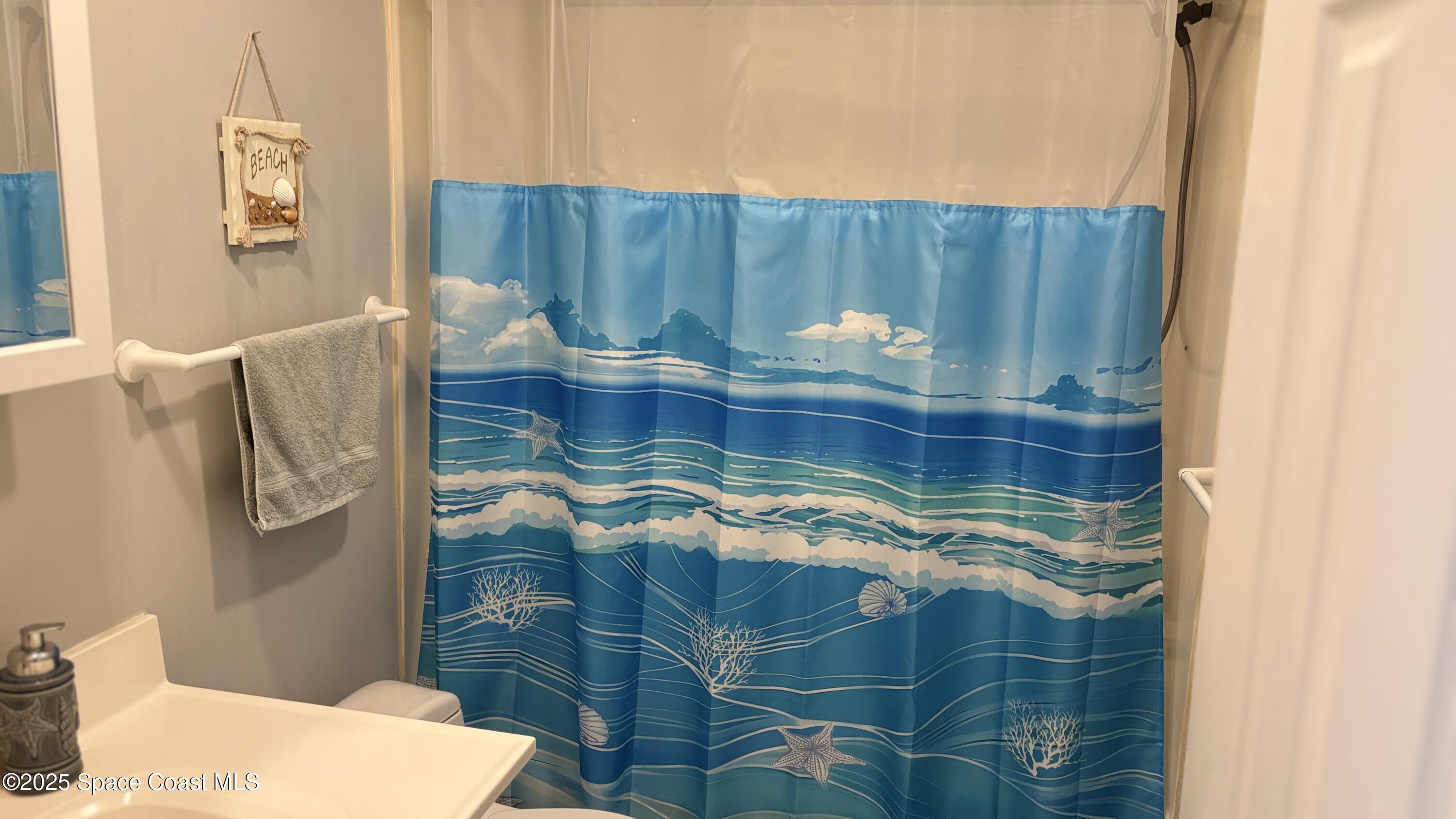 Undisclosed Address Cocoa Beach, FL 32931 - Photo 6 of 17 a bathroom with a sink and a mirror