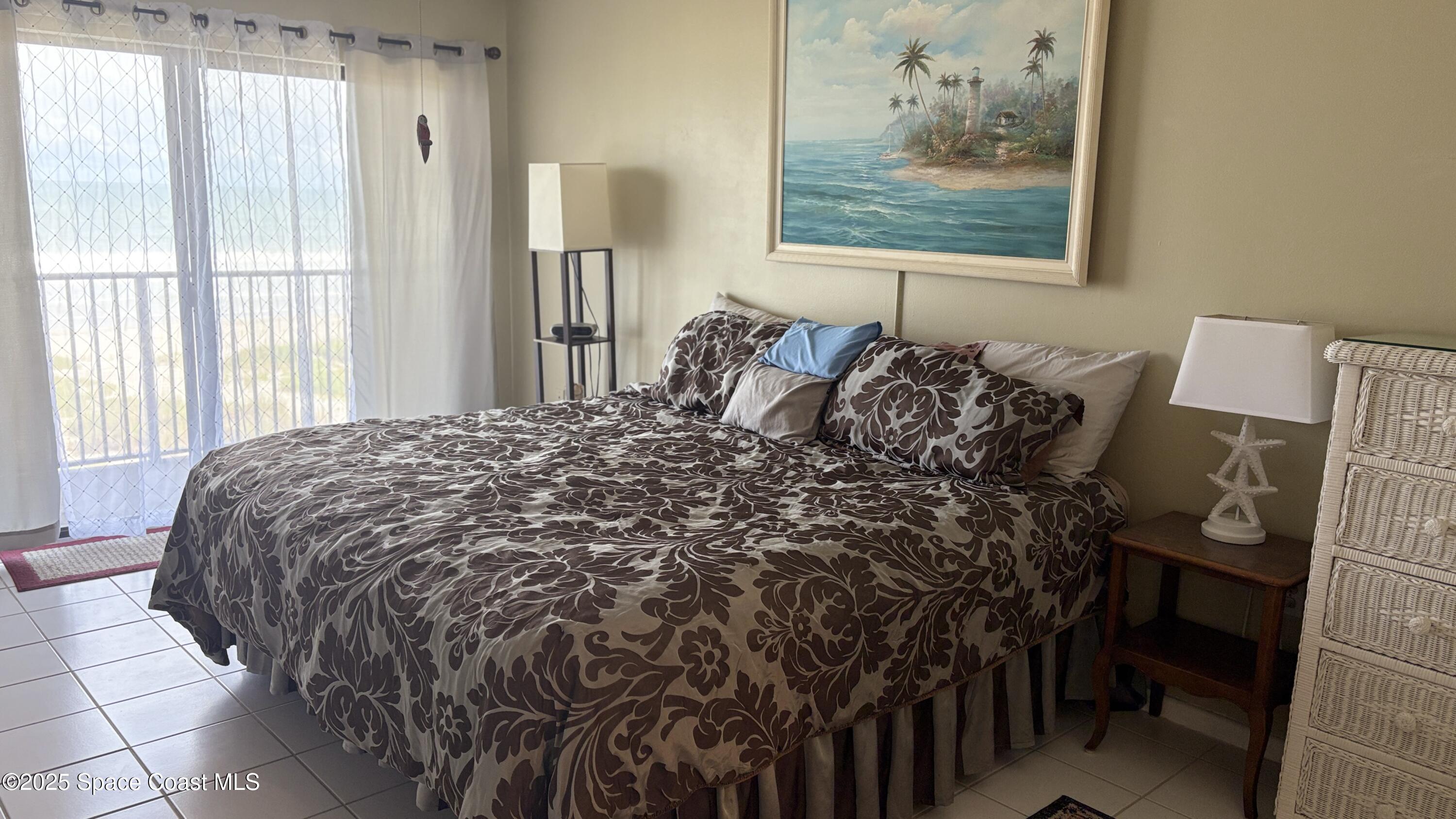 Undisclosed Address Cocoa Beach, FL 32931 - Photo 7 of 17 a bed sitting in a bedroom next to a window