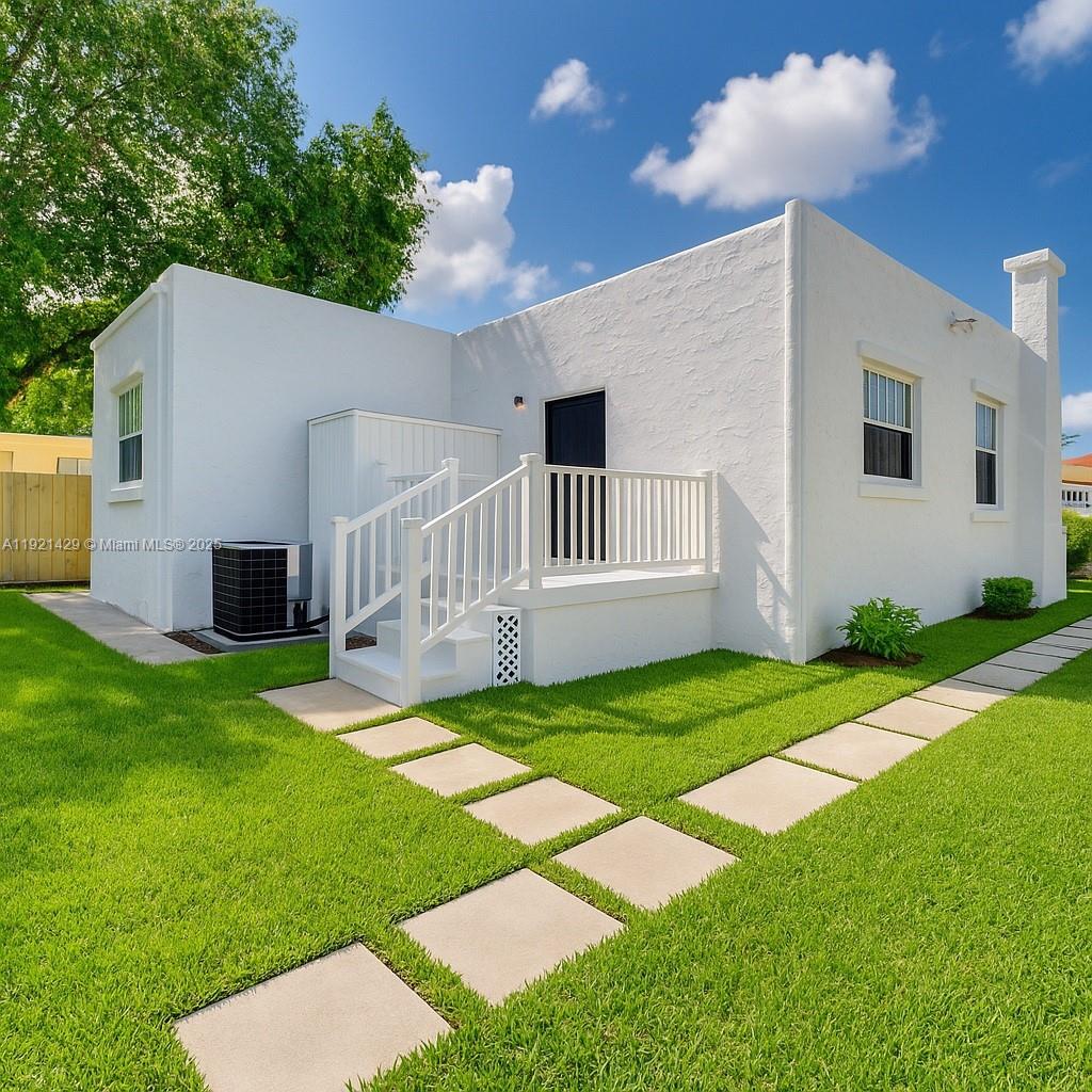 a view of backyard with a garden and entertaining space