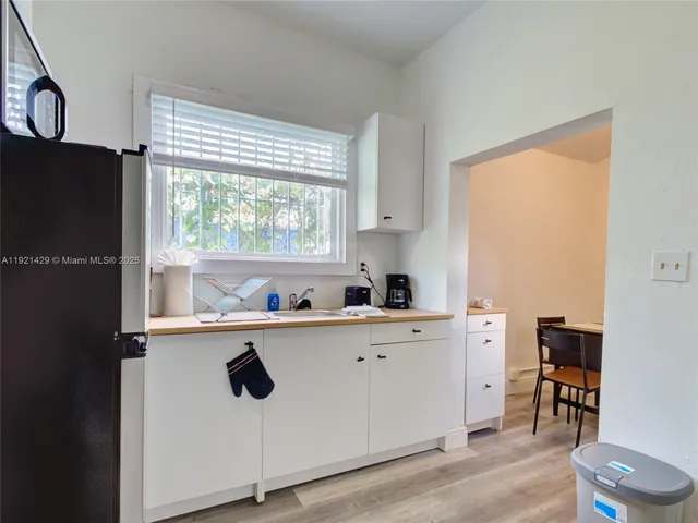 a kitchen with a window a sink and cabinets