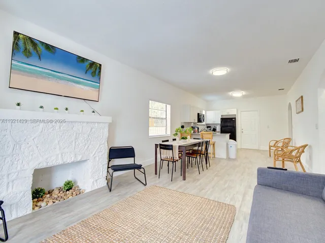 a living room with furniture a table and a fireplace