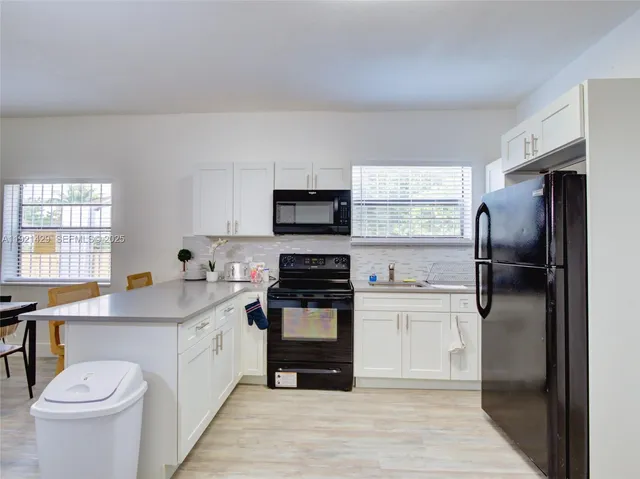 a kitchen with a sink stainless steel appliances and cabinets