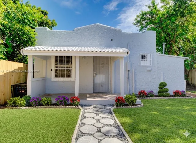 a front view of house with garden and garage