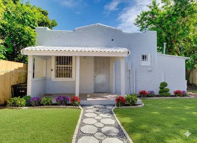 a front view of house with garden and garage