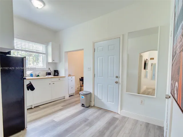 a view of a kitchen with closet and window