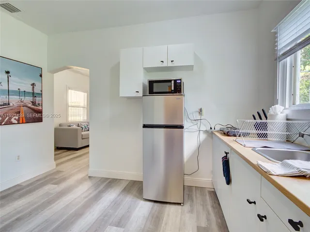 a kitchen with a sink and a refrigerator