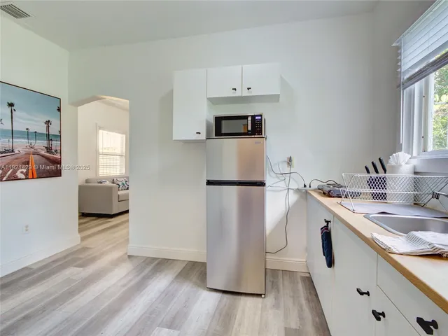 a kitchen with a sink and a refrigerator