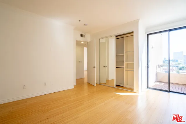 a view of an empty room with glass door
