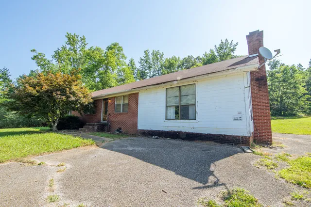 a kitchen with a sink appliances cabinets and dining table