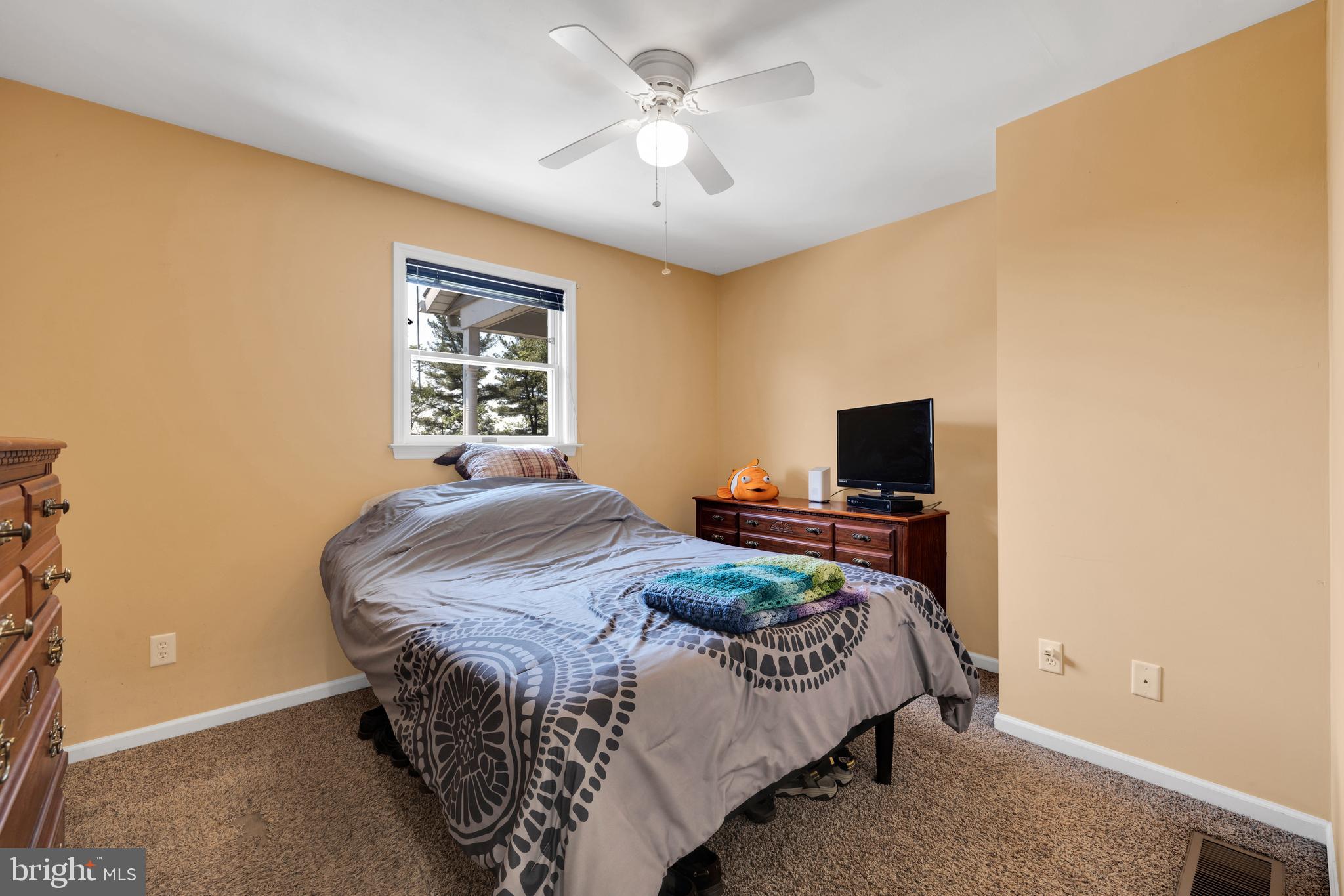 97 Bertolet Mill Road Oley, PA 19547 - Photo 19 of 35 a bedroom with a bed and a flat screen tv