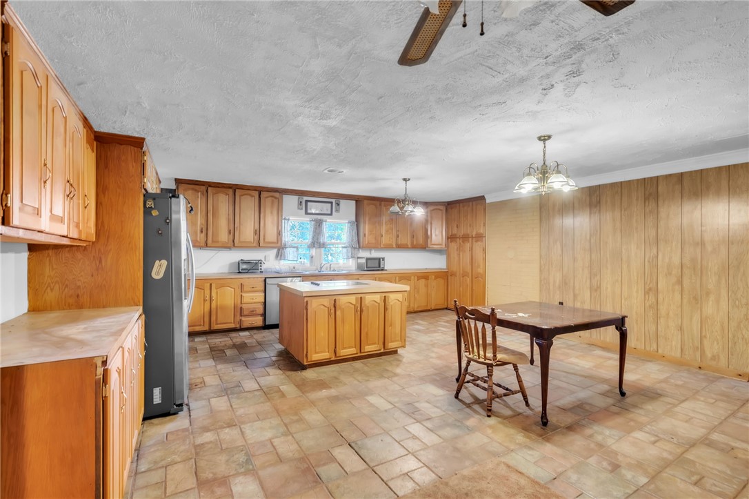 602 Harper Road Pendleton, SC 29670 - Photo 9 of 32 A spacious kitchen with classic wooden cabinetry and durable tiled flooring.