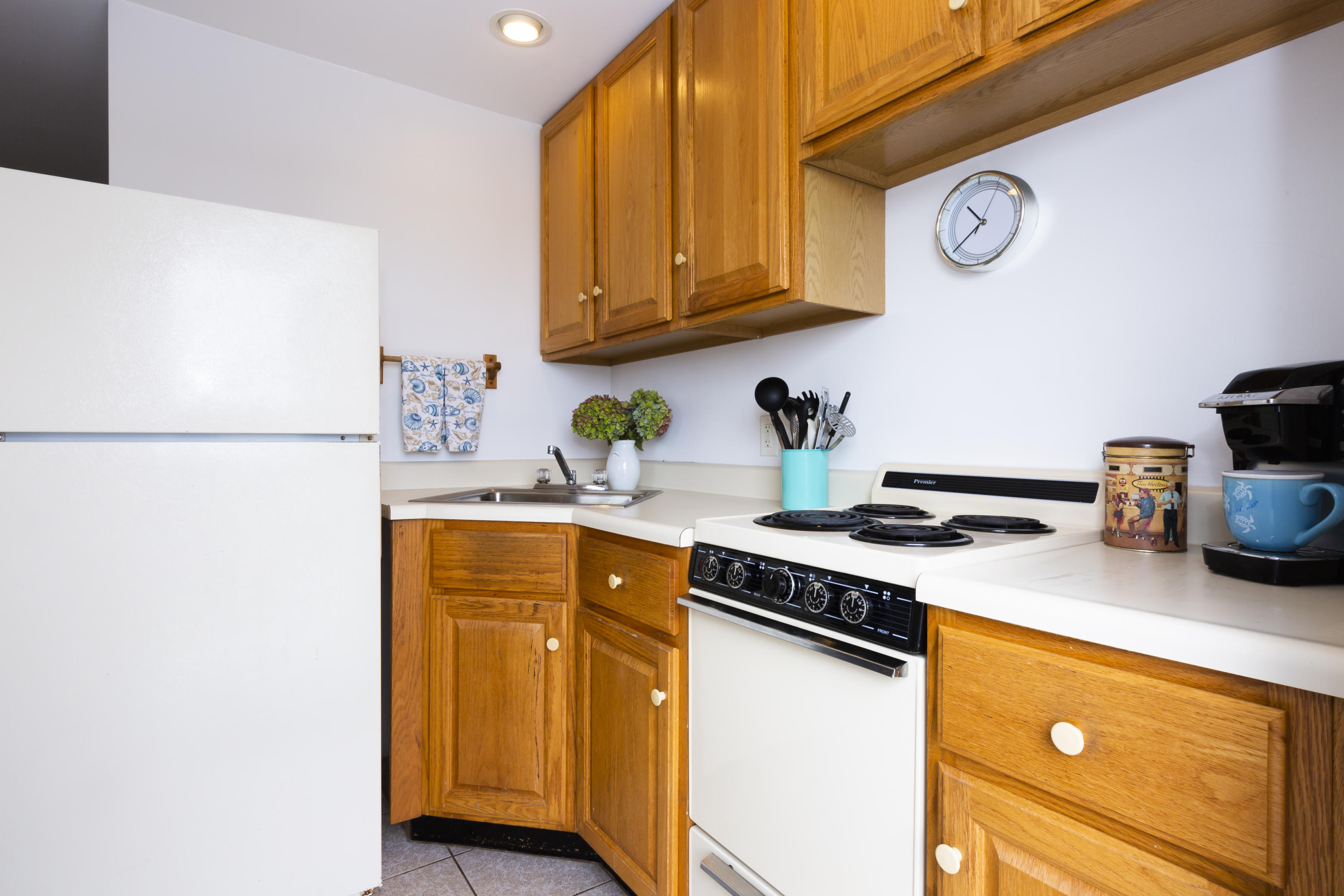 307 Shore Road, Unit 9 & SB2 Truro, MA 02666 - Photo 6 of 13 a kitchen with stainless steel appliances granite countertop a stove a sink and a refrigerator with wooden floor