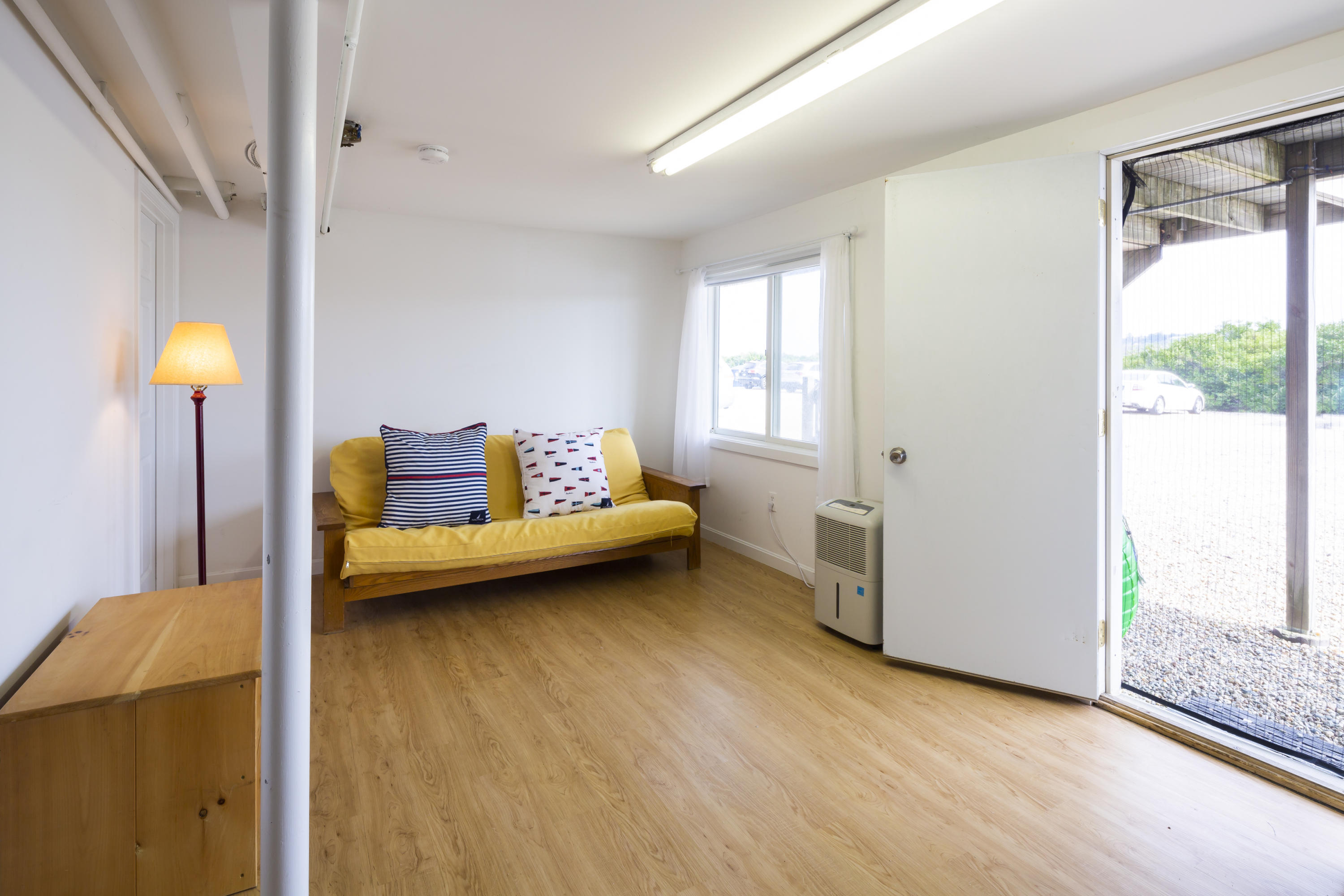 307 Shore Road, Unit 9 & SB2 Truro, MA 02666 - Photo 9 of 13 a bedroom with a bed and a window