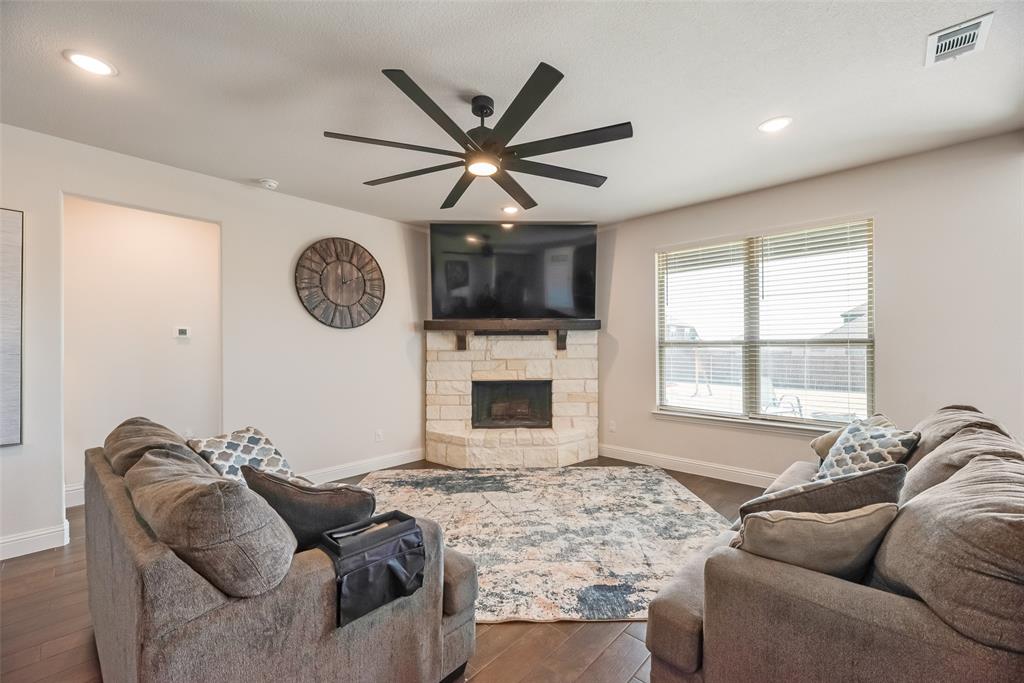561 Randys Way Pilot Point, TX 76258 - Photo 13 of 34 a living room with furniture a window and a flat screen tv