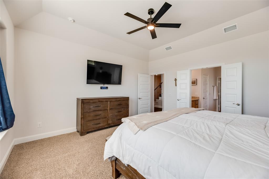 561 Randys Way Pilot Point, TX 76258 - Photo 15 of 34 a bedroom with a bed and a flat screen tv