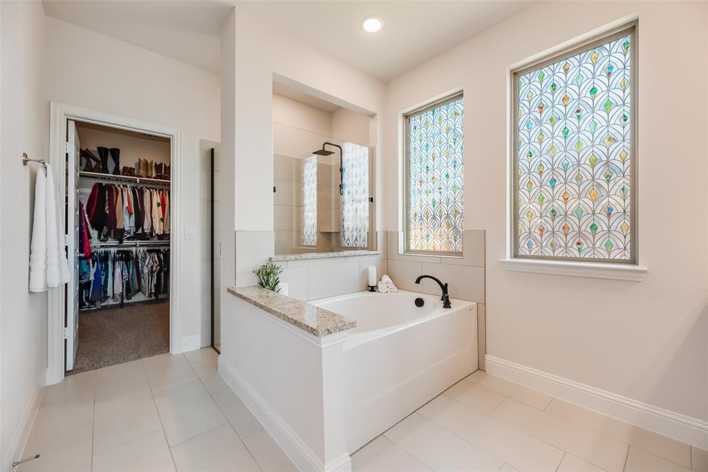 561 Randys Way Pilot Point, TX 76258 - Photo 16 of 34 a white bath tub sitting in a en suite bathroom next to a window