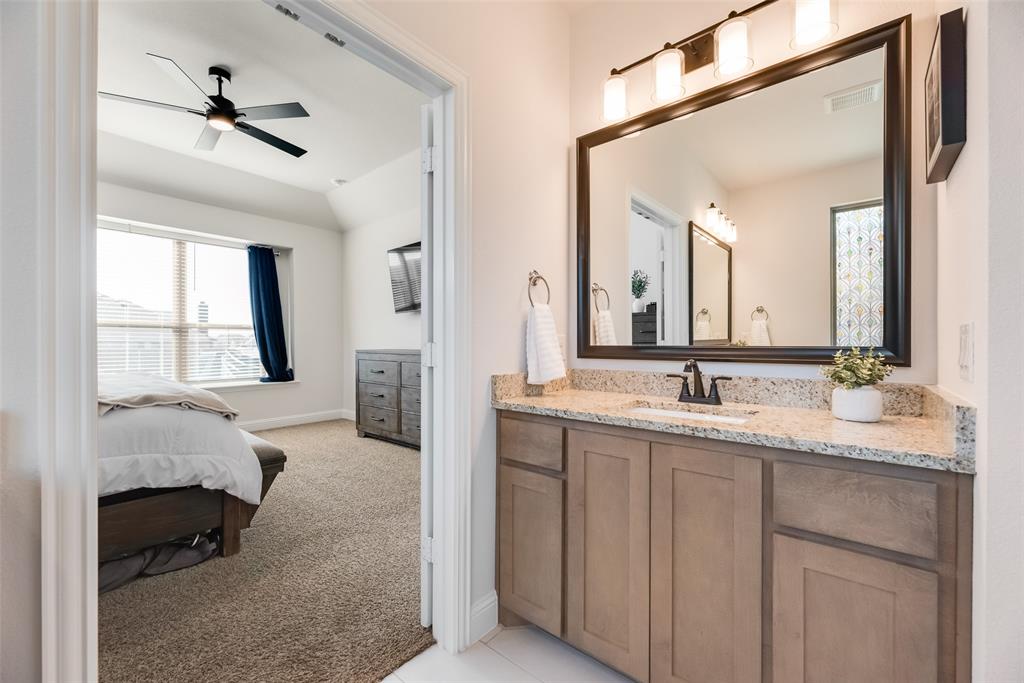 561 Randys Way Pilot Point, TX 76258 - Photo 18 of 34 a en suite bathroom with a granite countertop sink and a mirror