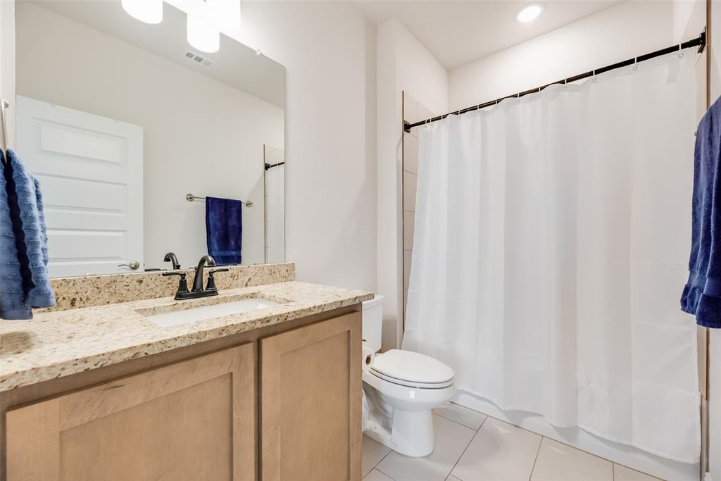 561 Randys Way Pilot Point, TX 76258 - Photo 23 of 34 a bathroom with a granite countertop sink and a mirror