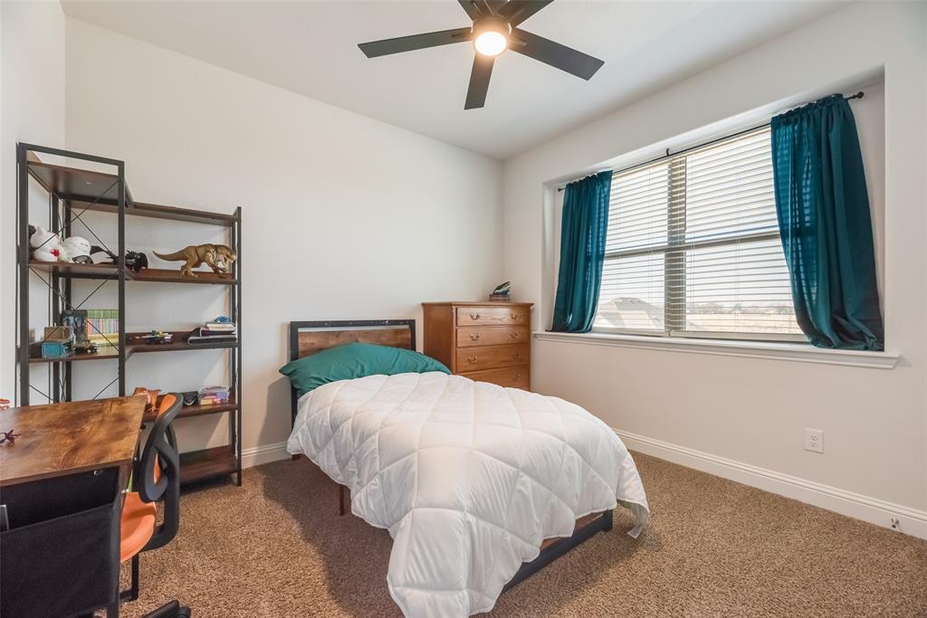 561 Randys Way Pilot Point, TX 76258 - Photo 24 of 34 a bed sitting in a bedroom next to a window