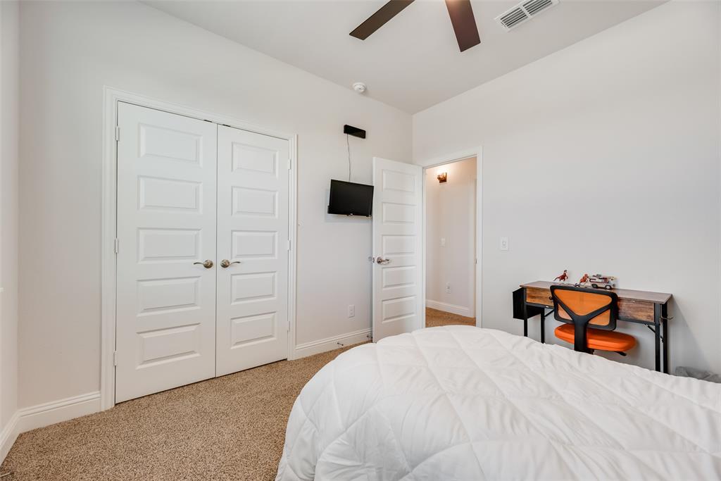561 Randys Way Pilot Point, TX 76258 - Photo 25 of 34 a bedroom with a bed and a tv on the dresser
