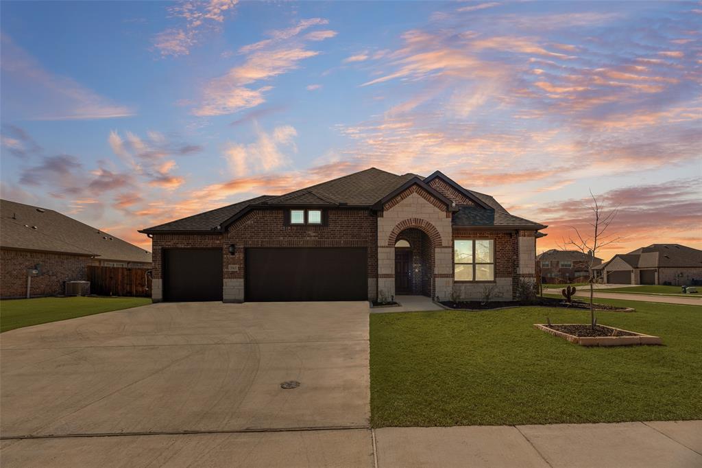 561 Randys Way Pilot Point, TX 76258 - Photo 33 of 34 a front view of a house with a yard and garage