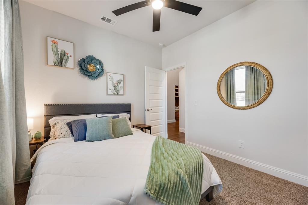 561 Randys Way Pilot Point, TX 76258 - Photo 6 of 34 a bedroom with a bed and a chandelier