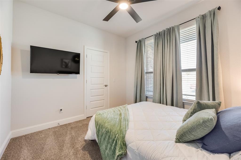 561 Randys Way Pilot Point, TX 76258 - Photo 7 of 34 a bedroom with a large bed and a flat screen tv