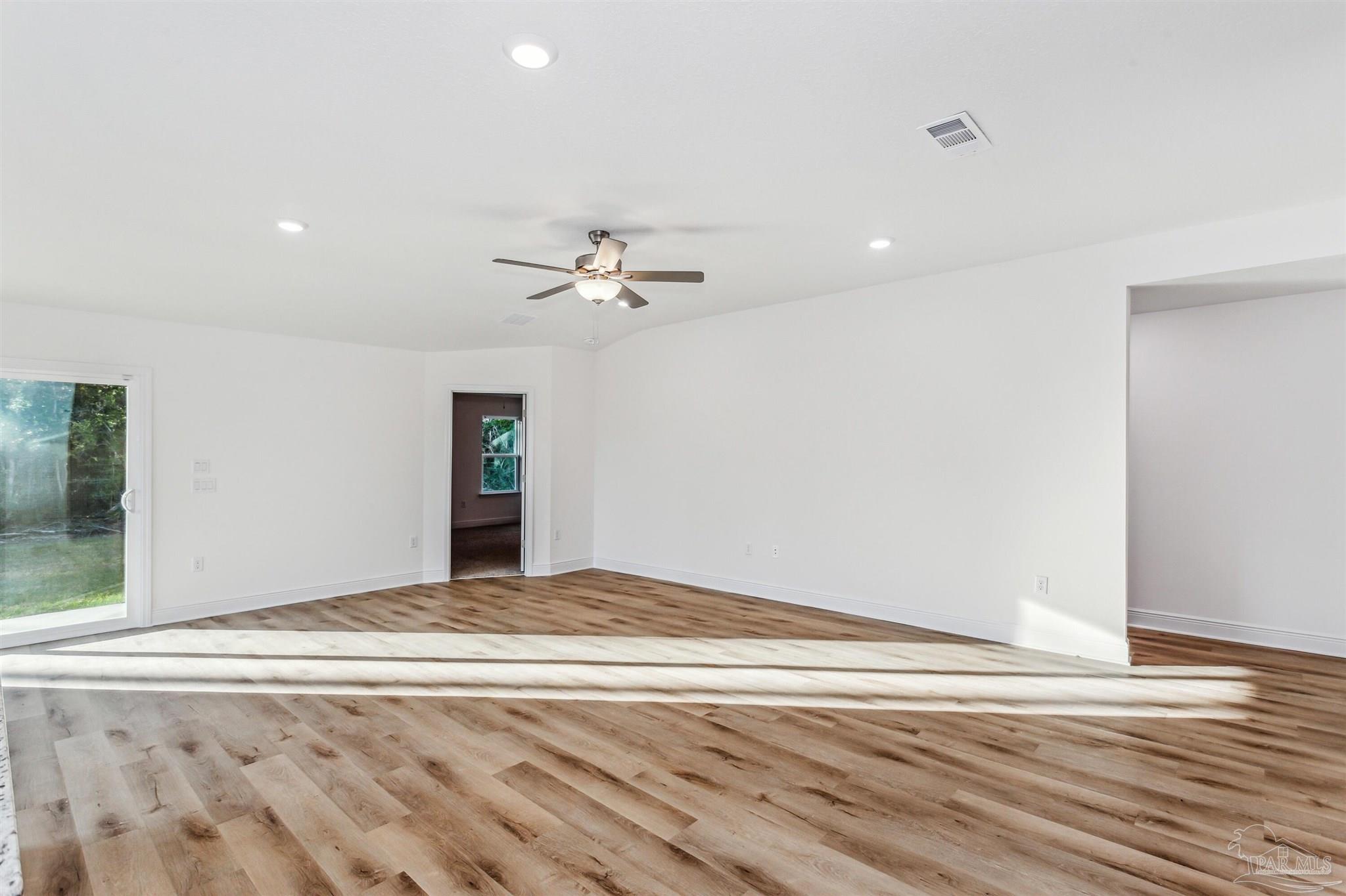 5009 Rainwater Road Milton, FL 32583 - Photo 14 of 29 a view of an empty room with wooden floor and a window