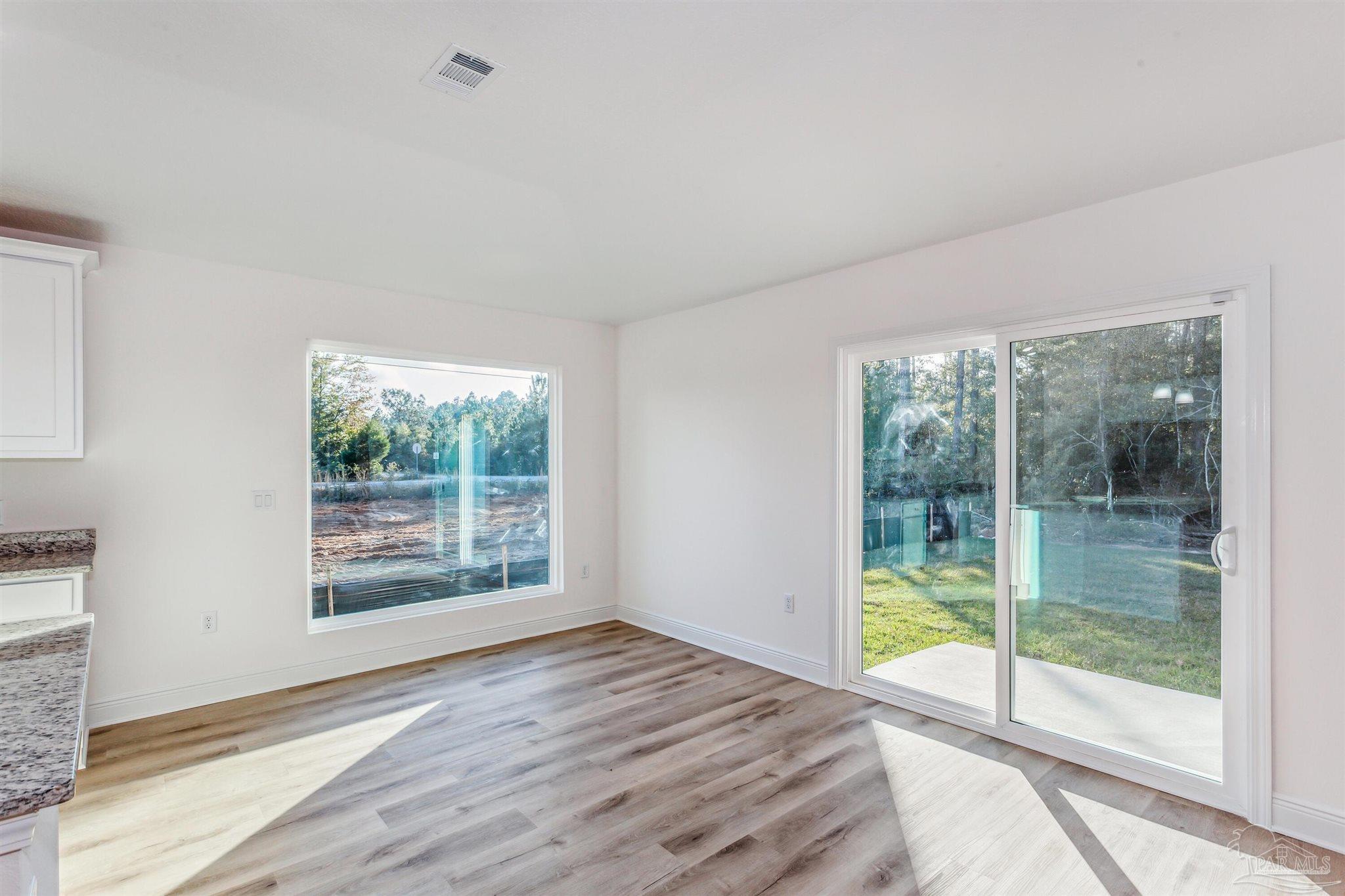 5009 Rainwater Road Milton, FL 32583 - Photo 16 of 29 a view of empty room with wooden floor and fan