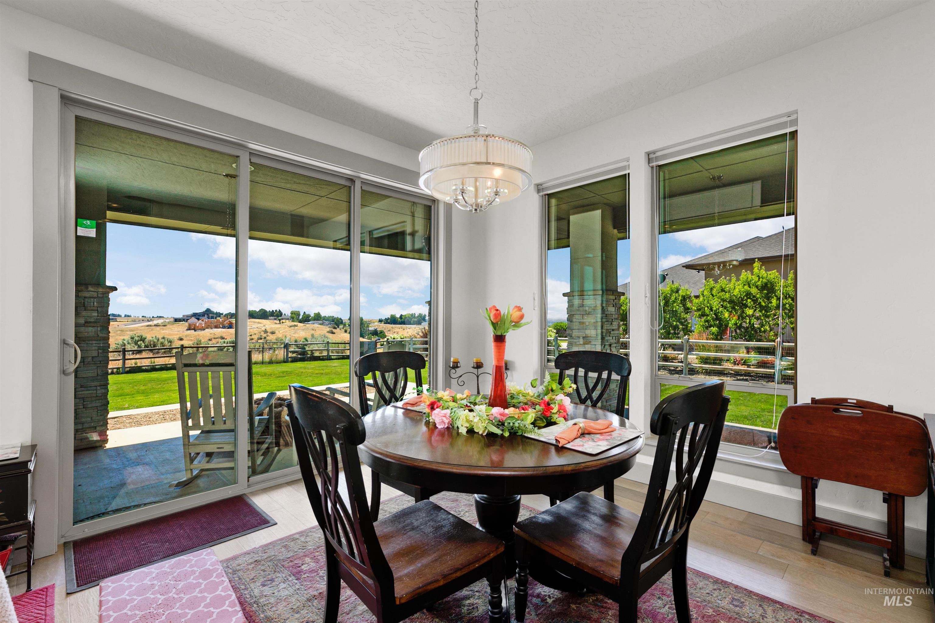 24398 Tombstone Ridge Court Middleton, ID 83644 - Photo 32 of 47 Dining area with large sliding glass doors and multiple windows