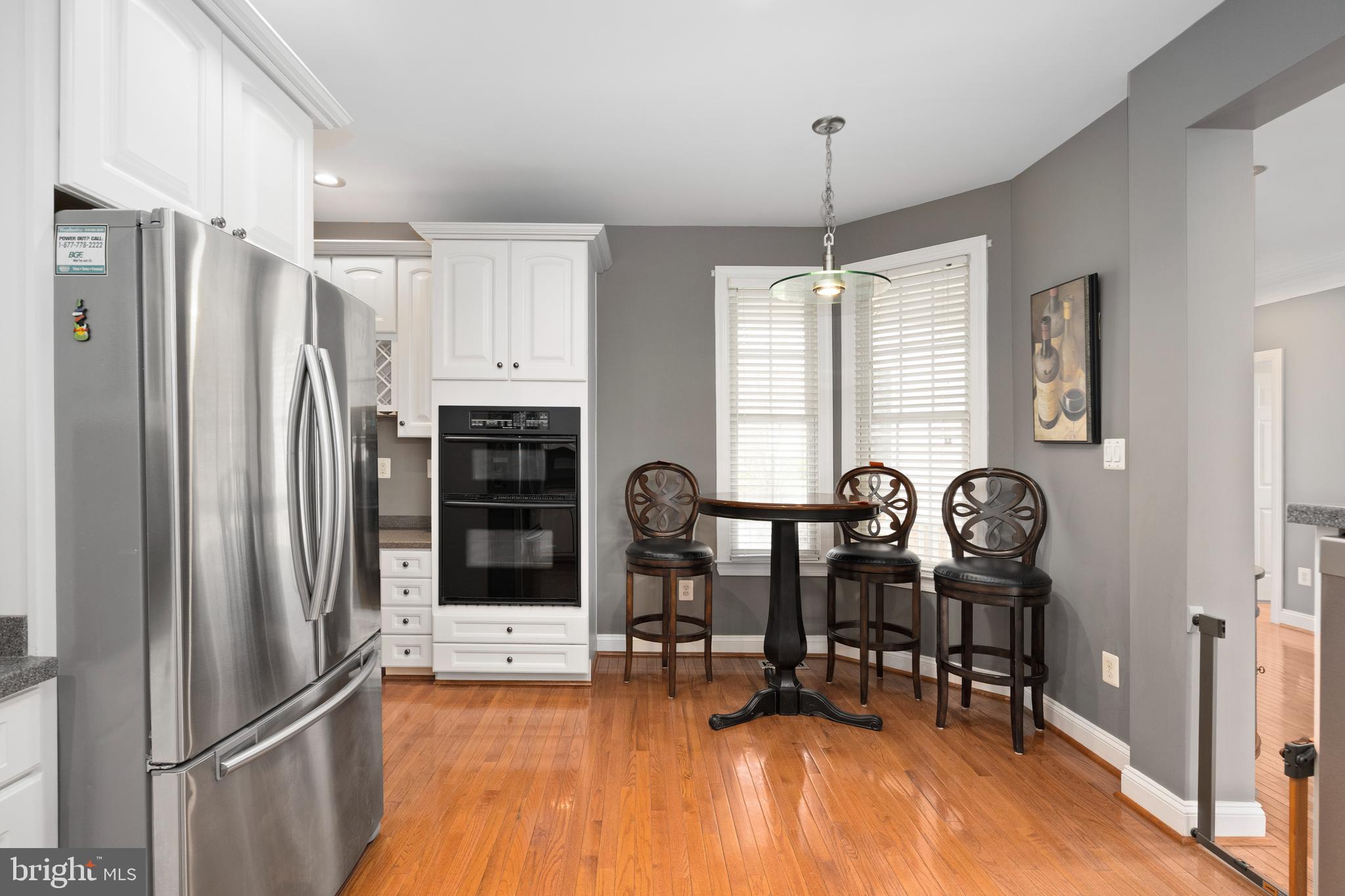 818 Hidden Bluff Circle Catonsville, MD 21228 - Photo 11 of 36 a kitchen with stainless steel appliances a refrigerator a table and chairs