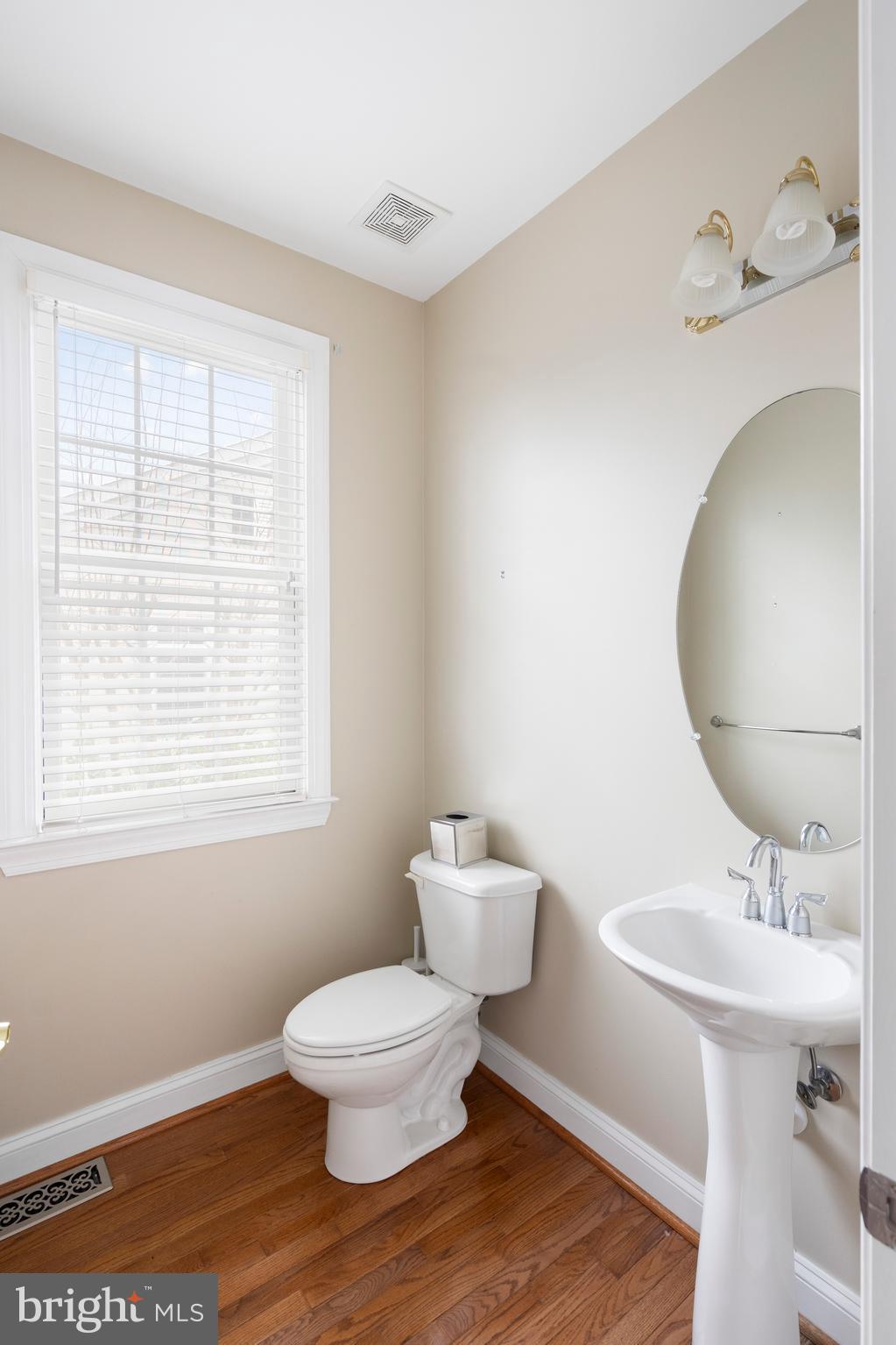 818 Hidden Bluff Circle Catonsville, MD 21228 - Photo 14 of 36 a bathroom with a toilet a sink and mirror