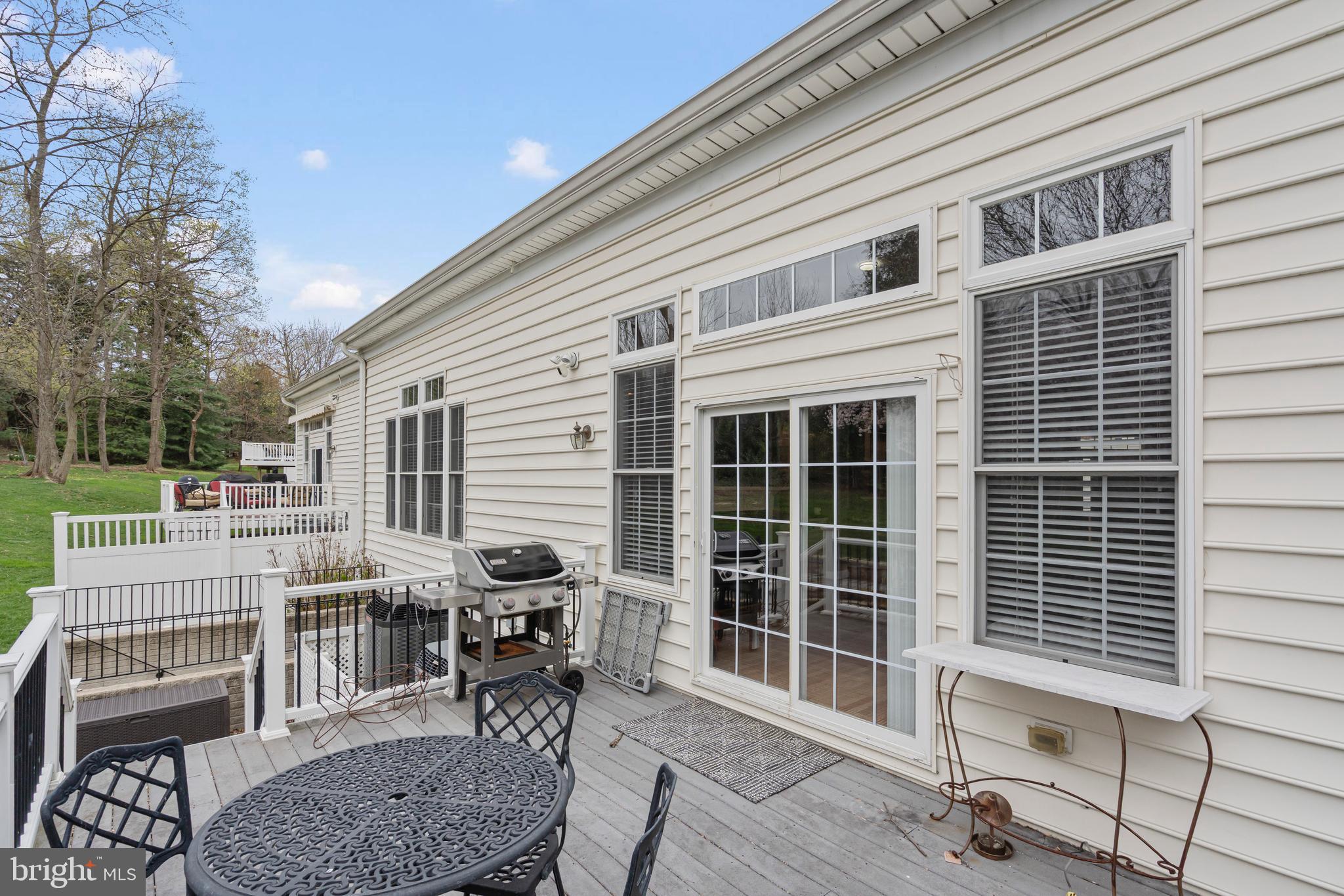 818 Hidden Bluff Circle Catonsville, MD 21228 - Photo 30 of 36 a view of a deck with table and chairs with wooden floor and fence