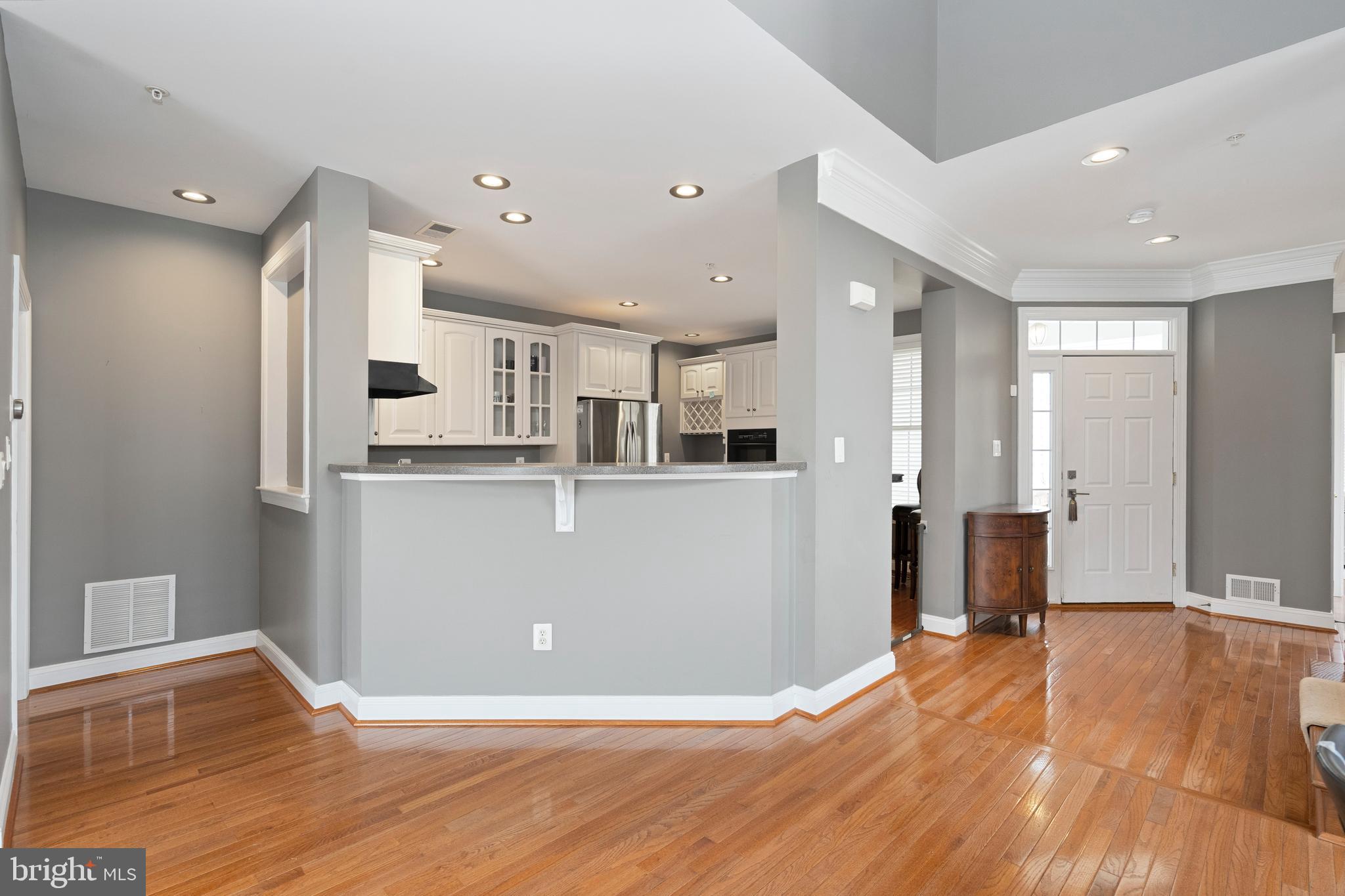818 Hidden Bluff Circle Catonsville, MD 21228 - Photo 7 of 36 a living room with stainless steel appliances kitchen island granite countertop wooden floor and cabinets