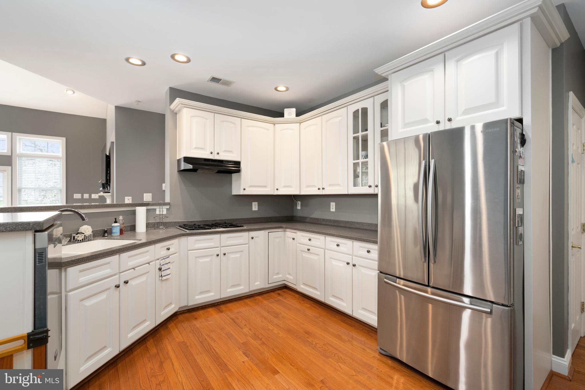 818 Hidden Bluff Circle Catonsville, MD 21228 - Photo 8 of 36 a kitchen with stainless steel appliances granite countertop a refrigerator sink and white cabinets