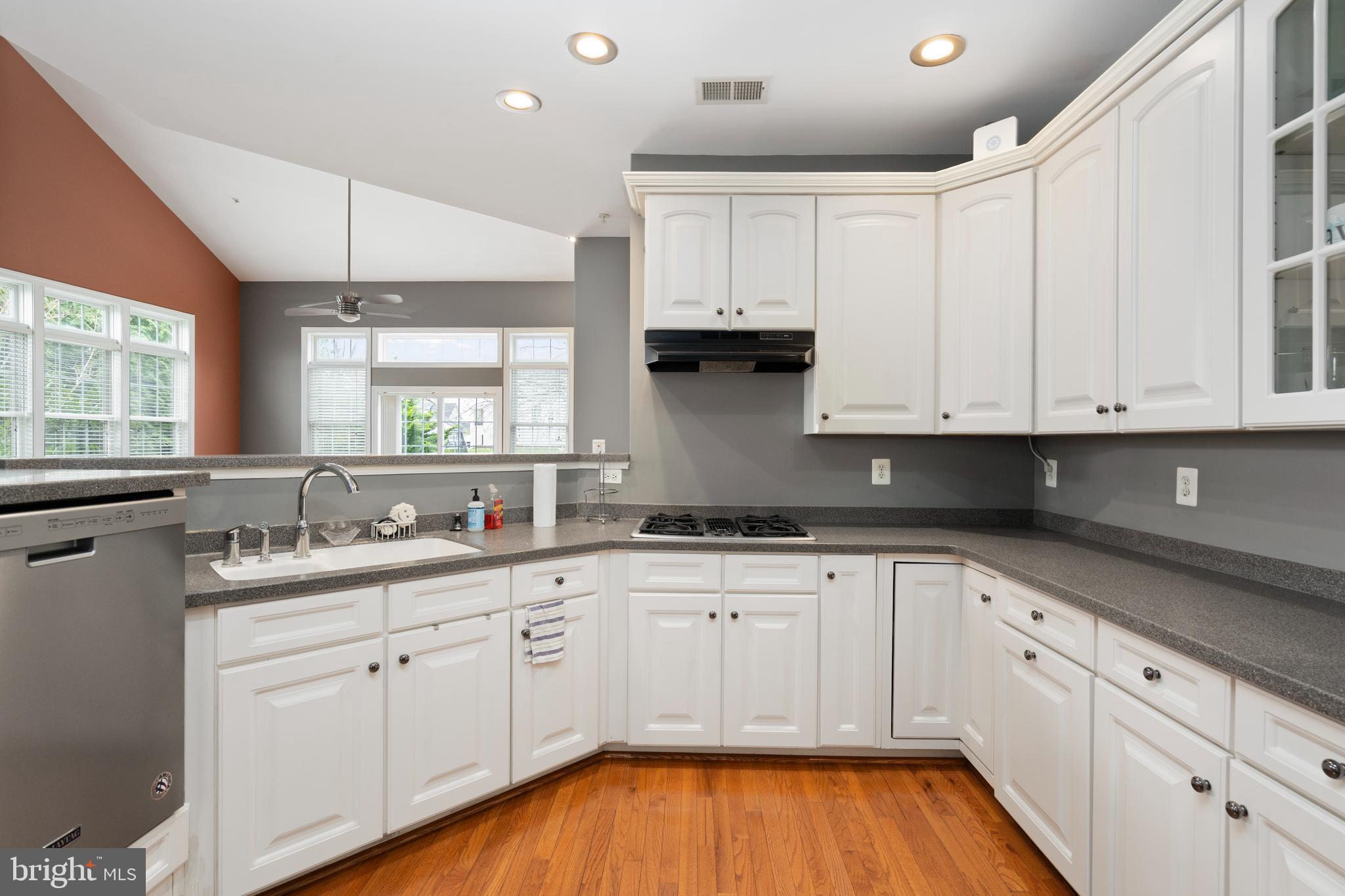 818 Hidden Bluff Circle Catonsville, MD 21228 - Photo 9 of 36 a kitchen with wooden cabinets and sink