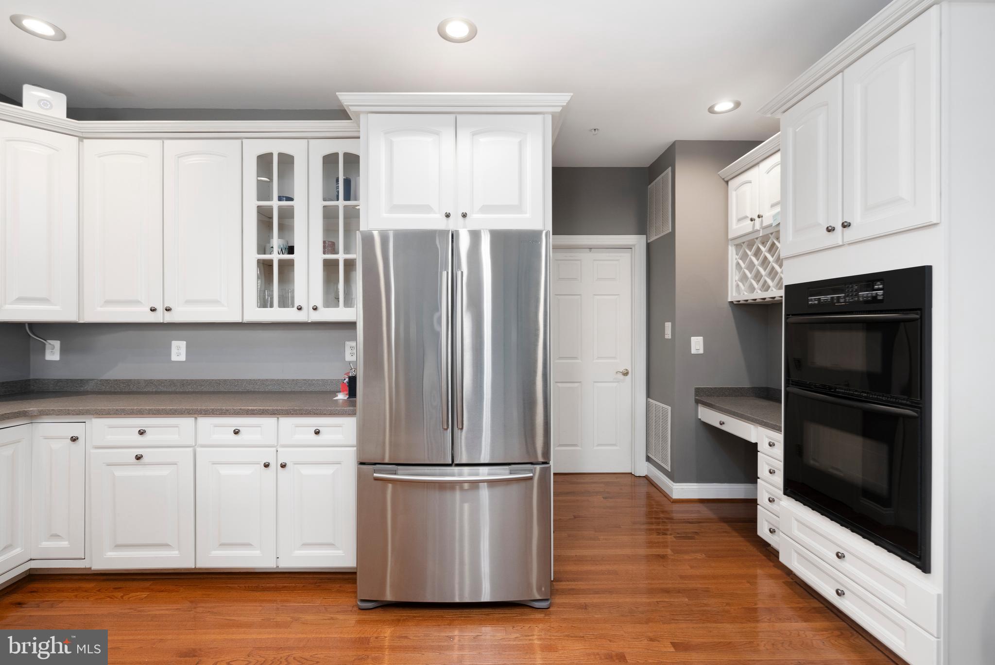 818 Hidden Bluff Circle Catonsville, MD 21228 - Photo 10 of 36 a kitchen with a refrigerator stove and white cabinets