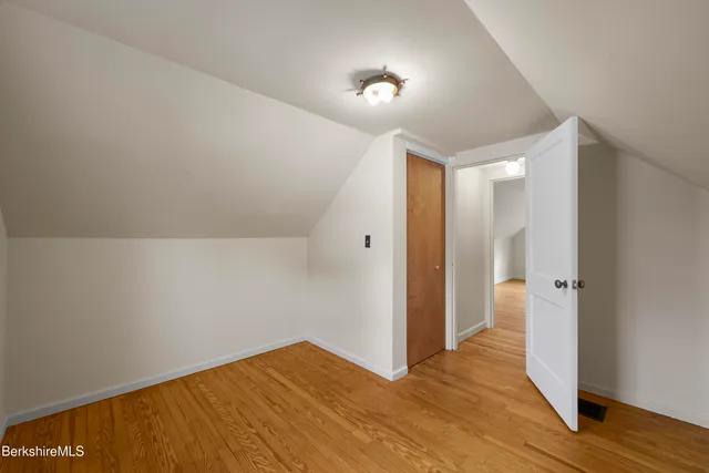 a view of hallway with wooden floor