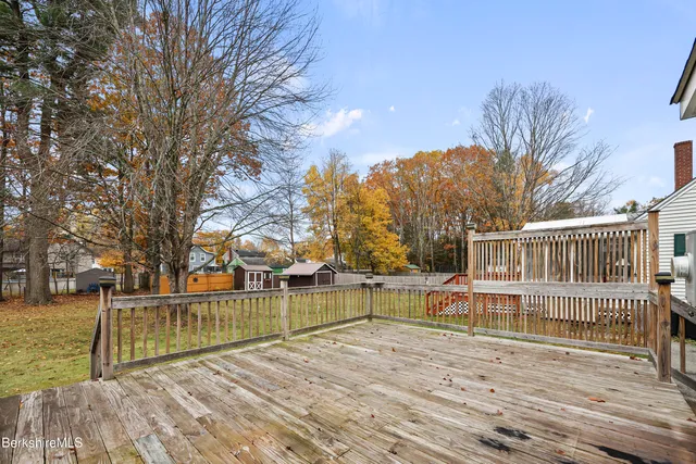 a view of a house with wooden floor and fence