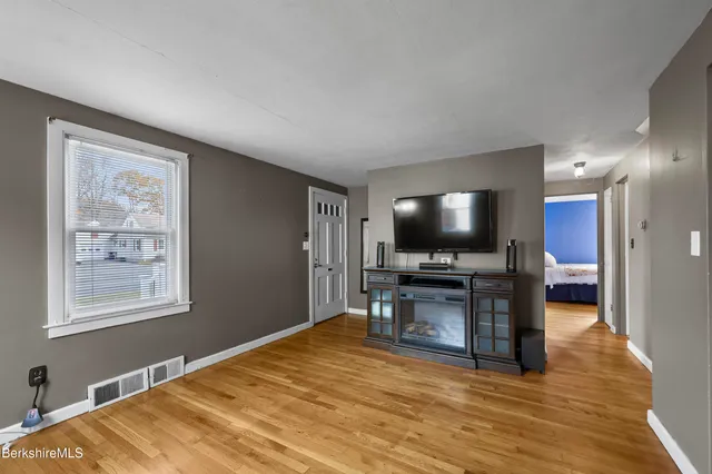 a view of a livingroom with furniture and a flat screen tv