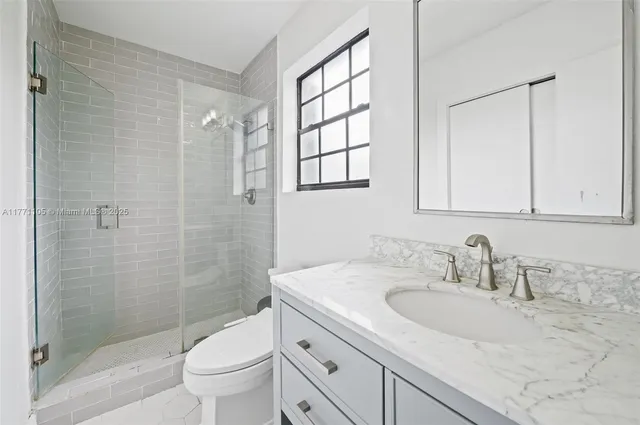 a bathroom with a sink toilet and shower