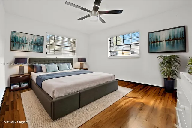 a bedroom with a bed and a painting on the wall