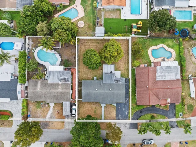 an aerial view of residential houses with outdoor space