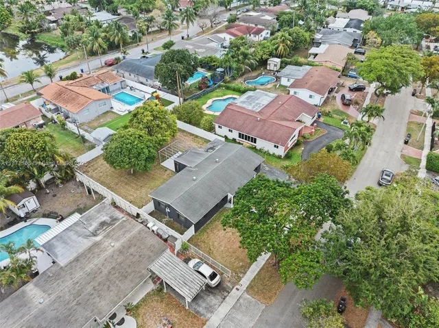 an aerial view of residential houses with outdoor space