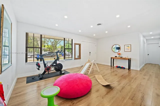 a living room with furniture a floor to ceiling window and a table