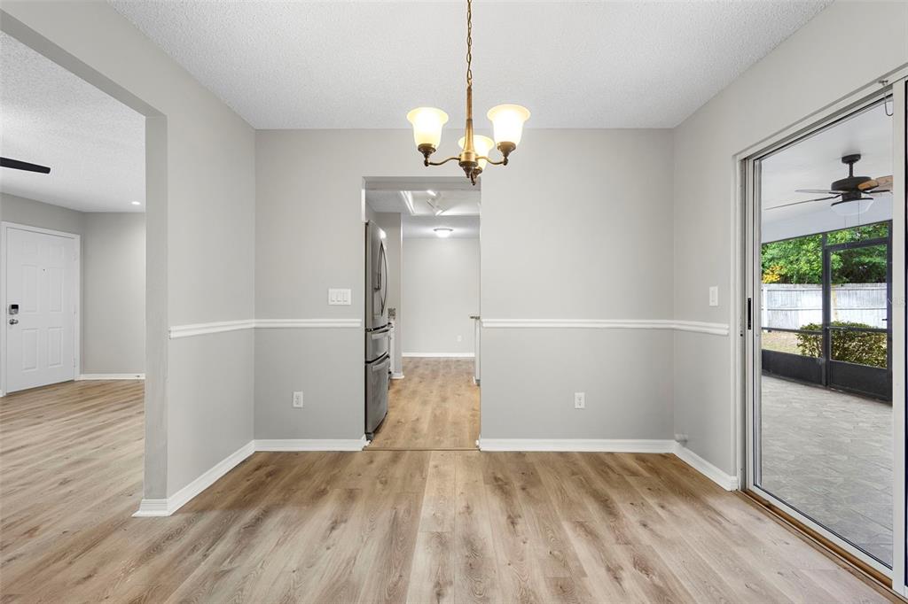 1031 Abeline Drive Deltona, FL 32725 - Photo 13 of 37 a view of empty room with wooden floor and fan