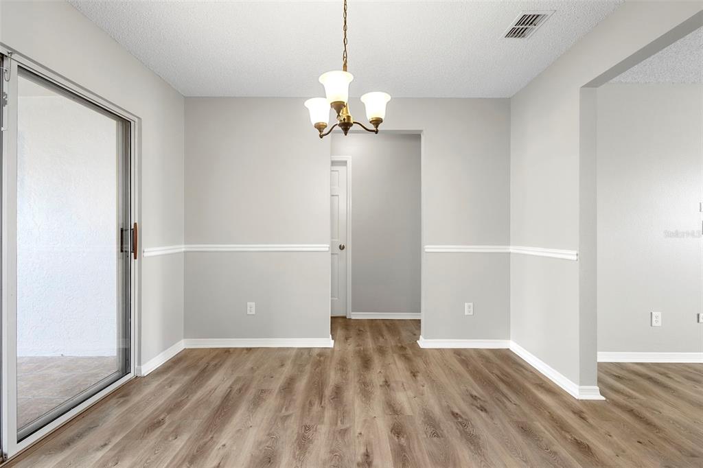 1031 Abeline Drive Deltona, FL 32725 - Photo 16 of 37 wooden floor in an empty room with a window
